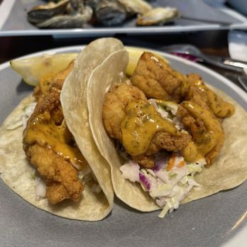 Mudbugs Cajun Kitchen - Grouper tacos. Very good. Would get again.  Slaw was cool and crunchy. Sauce was a little tangy and the fish was perfectly cooked. - Cajun/Creole Near Me - Sanibel, Florida