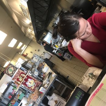 Mr Cheng - a woman sitting at a counter in a restaurant - American Near Me - Mount Holly, New Jersey