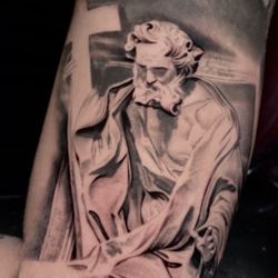 Hollywood Stars Tattoo - "Captivating saint statue tattoo, showcasing divine artistry and detail. Book now for your spiritual design."