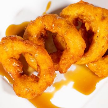 Inka Peruvian Cuisine - Picarones. Peruvian fried donuts. Made with wheat flour dough mixed with pumpkin, and sweet potato, bathed in Chancaca honey. - Peruvian Near Me - Palm Springs, California Inka Peruvian Cuisine - Picarones. Peruvian fried donuts. Made with wheat flour dough mixed with pumpkin, and sweet potato, bathed in Chancaca honey. - Peruvian Near Me - Palm Springs, California