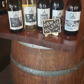 Cabal Cellars - a selection of wine bottles on a barrel - Wine Tasting Room Near Me - Tombstone, Arizona
