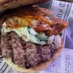 Fired Up Bar & Grill - Jalapeño popper burger. It looks like bacon but it's torched pepper Jack cheese (see review).