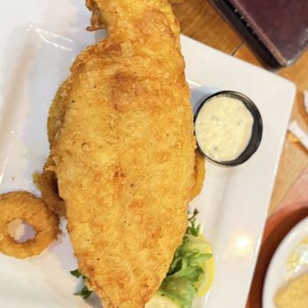 Ford's Garage Dearborn - Big piece of Catfish with onion rings - Burgers Near Me - Dearborn, Michigan Ford's Garage Dearborn - Big piece of Catfish with onion rings - Burgers Near Me - Dearborn, Michigan