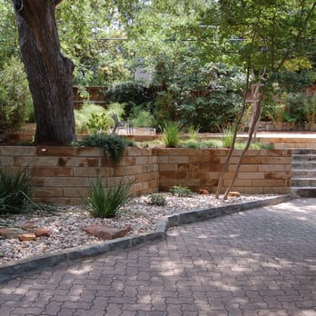 Verdi - a brick patio with steps leading up to a tree - Landscape Architects or Designers Near Me - Austin, Texas