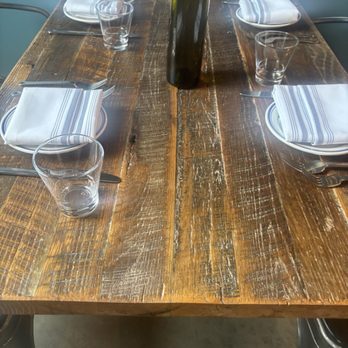 Urban Kitchen - Table setting photo. Water comes in wine bottles! - New American Near Me - Bozeman, Montana Urban Kitchen - Table setting photo. Water comes in wine bottles! - New American Near Me - Bozeman, Montana
