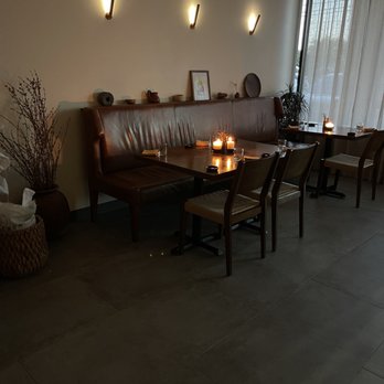 Tatemó - a living room with a couch and a table with candles on it - Mexican Near Me - Houston, Texas Tatemó - a living room with a couch and a table with candles on it - Mexican Near Me - Houston, Texas