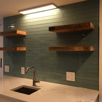 Exemplary Finishes - a kitchen counter with a sink - General Contractors Near Me