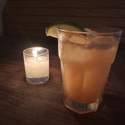 a drink and a candle on a table