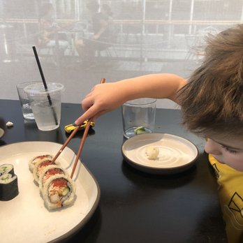 Bamboo Sushi - Charlie going for the spicy roll. - Sushi Bars Near Me - San Ramon, California
