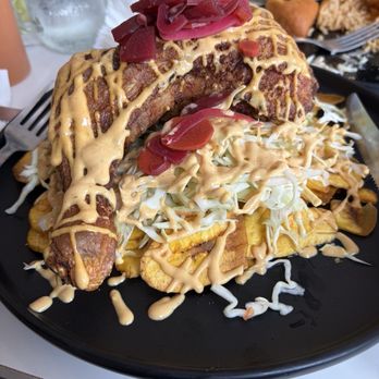 Fogata Latin Fusion - Chicken with plantain chips and cabbage POLLO CON TOJADAS - Latin American Near Me - Houston, Texas Fogata Latin Fusion - Chicken with plantain chips and cabbage POLLO CON TOJADAS - Latin American Near Me - Houston, Texas