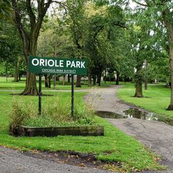 Oriole Park - The sign at the park is filled with weeds and other ugly things. This park gets tons of money. There's no excuse for this weed filled box.