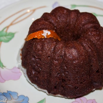 Boozy Bundtz - a chocolate bundt cake on a floral plate - Bakeries Near Me Boozy Bundtz - a chocolate bundt cake on a floral plate - Bakeries Near Me