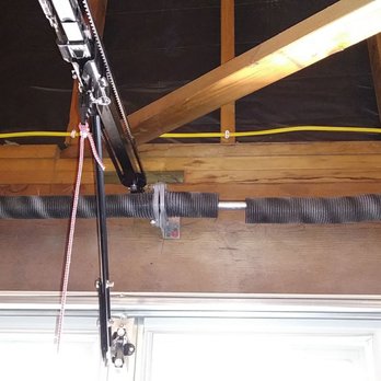 First Garage Door - Before Photo. Broken Tension Spring On The Right. - Garage Door Services Near Me - Irvine, California
