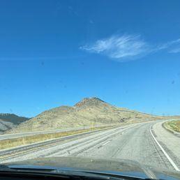 a view of a highway with mountains in the distance