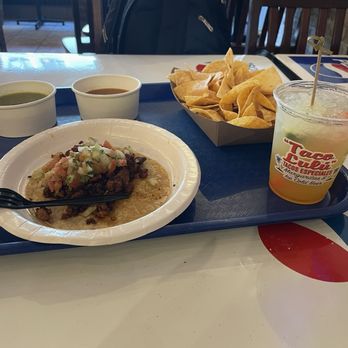 Taco Lulú - Chips and Green Salsa, Red Salsa, peach margarita, "Pastor" Marinated Pork Taco Lulú style - Mexican Near Me - Chicago, Illinois Taco Lulú - Chips and Green Salsa, Red Salsa, peach margarita, "Pastor" Marinated Pork Taco Lulú style - Mexican Near Me - Chicago, Illinois