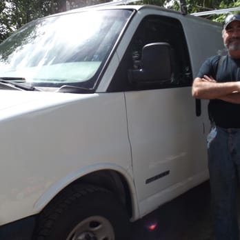 Dan's Plumbing - a man standing in front of a van - General Contractors Near Me