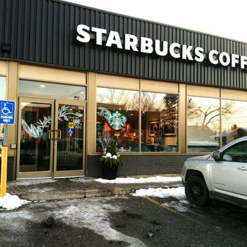 Starbucks - a car parked in front of a starbucks coffee shop - Coffee & Tea Near Me - Toronto, Ontario