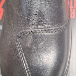 Motocard - Leather boots with scratch across the top.