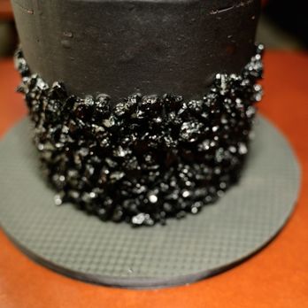 Sweet Boutique Bakery - a chocolate cake with black icing and sprinkles - Custom Cakes Near Me - Charlotte, North Carolina