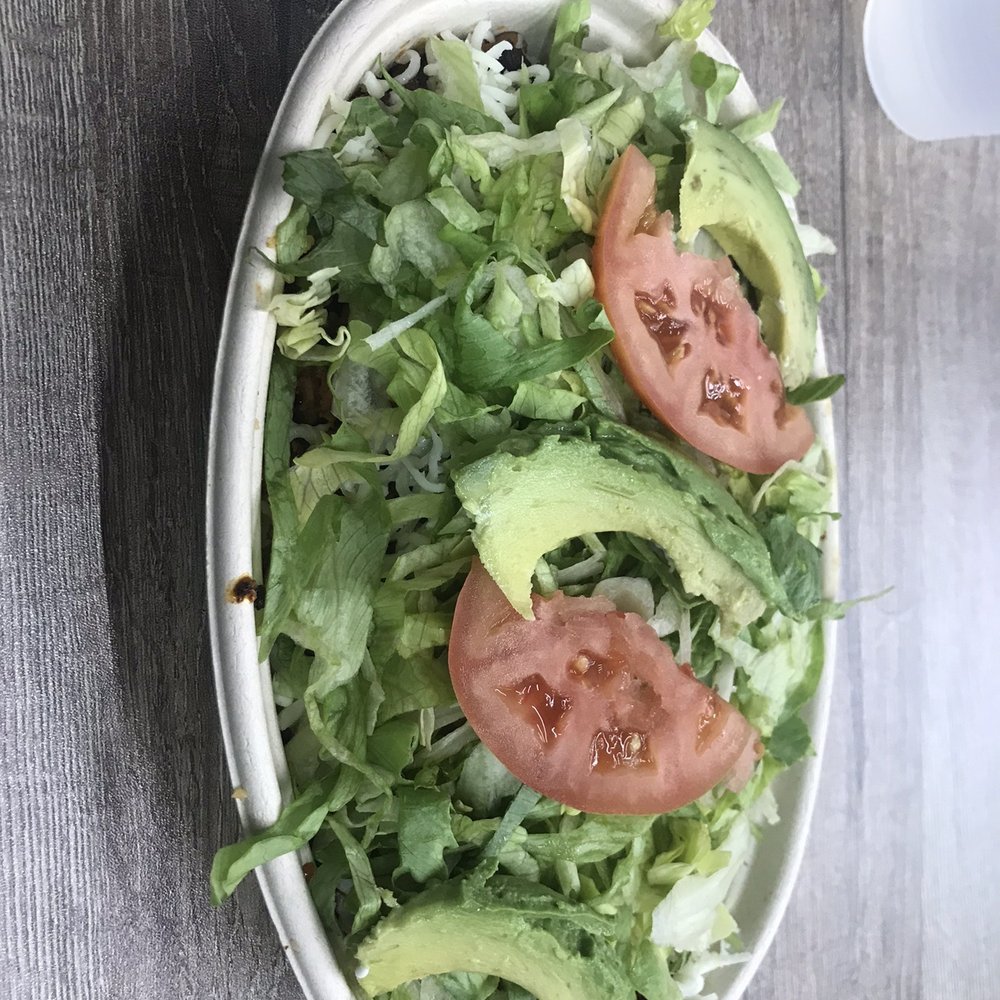 a salad with tomatoes and avocado
