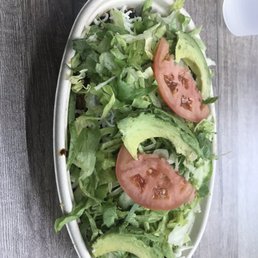 a salad with tomatoes and avocado