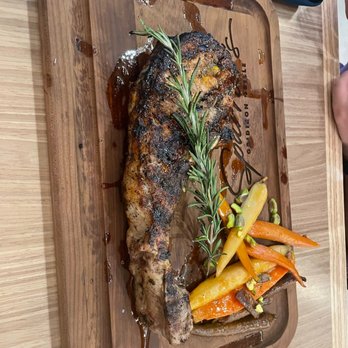 Spurrier's Gridiron Grille - Tomahawk pork chop - American Near Me - Gainesville, Florida Spurrier's Gridiron Grille - Tomahawk pork chop - American Near Me - Gainesville, Florida