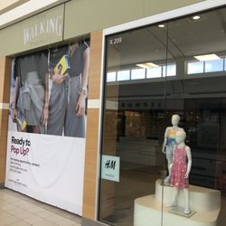 Walking - Empty closed store with blocked entrance under store name