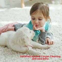 Satisfied System Carpet Cleaning - Little girl and puppy laying on fresh cleaned carpet cleaned by Satisfied System.