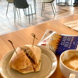 Cooper's Coffee + Eatery - Inside the cafe showing the Gouda Turkey sandwich, chips, & cappuccino.