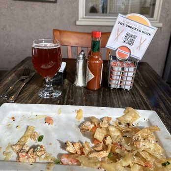 The Crooked Duck - What's left of my Yokohama Sesame Chicken Wonton Nachos. Guava Mimosa - New American Near Me - Long Beach, California The Crooked Duck - What's left of my Yokohama Sesame Chicken Wonton Nachos. Guava Mimosa - New American Near Me - Long Beach, California