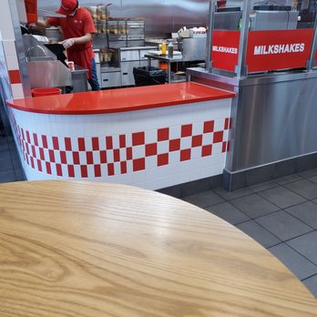 Five Guys - a man preparing food in a restaurant kitchen - Burgers Near Me - Chamblee, Georgia