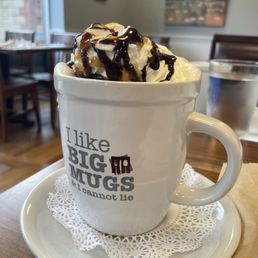 a cup of hot chocolate with whipped cream and chocolate sauce a cup of hot chocolate with whipped cream and chocolate sauce