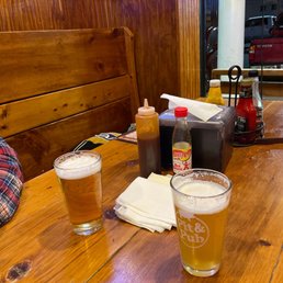 a table with two glasses of beer