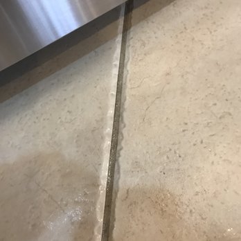 Premier Pest Management - Cleaning up pesticide after John sprayed under appliances. - Pest Control Near Me - Naples, Florida