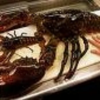 Sea Pier - a person cutting up a lobster on a cutting board - Seafood Markets Near Me - Boothbay Harbor, Maine