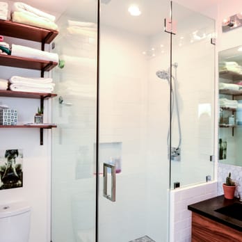 Dunros Construction - a bathroom with a glass shower - General Contractors Near Me
