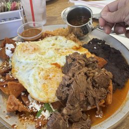 Special menu item birria chilaquiles rojos with over easy eggs