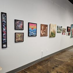 Art On 1st - Many of the artworks hanging from one of the walls.