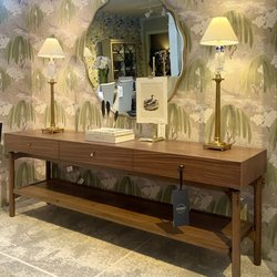 Mitchell's Interiors - Solid walnut credenza with Visual Comfort Lighting on our showroom floor.