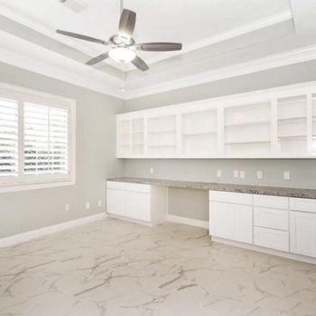 Expert Contracting Firm - a kitchen with white cabinets and marble countertops - General Contractors Near Me - Humble, Texas