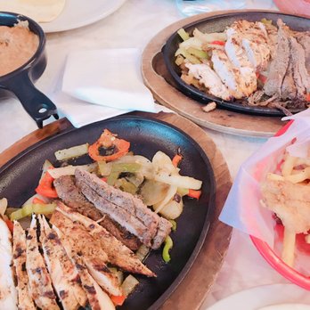 Chuy's - Combo fajitas, w grilled onions & peppers. Served w tortillas, lettuce, guac, sour cream, cheese, pico de gallo, rice & beans. - Tex-Mex Near Me - Lutz, Florida