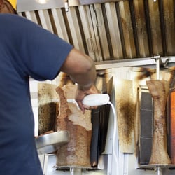 Carving the beef and lamb gyro cones