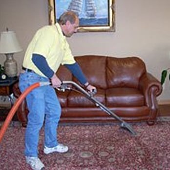 J. Benson Construction - a man cleaning a living room - General Contractors Near Me - Hopkins, Minnesota J. Benson Construction - a man cleaning a living room - General Contractors Near Me - Hopkins, Minnesota
