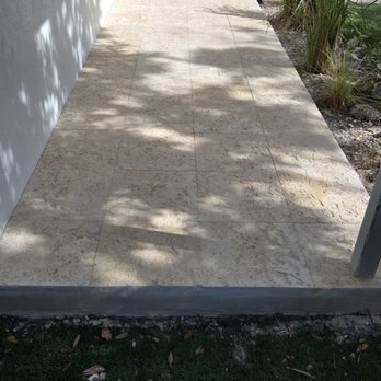 S.F. Concrete Technology - Travertine pavers installed in a front patio with river rocks - Masonry/Concrete Near Me - Miami, Florida S.F. Concrete Technology - Travertine pavers installed in a front patio with river rocks - Masonry/Concrete Near Me - Miami, Florida