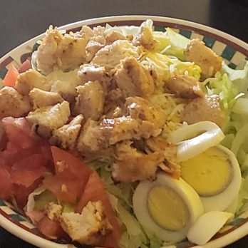 Pour House Bar & Grill - a plate of chicken salad with hard boiled eggs and tomatoes - Pubs Near Me - Malcom, Iowa