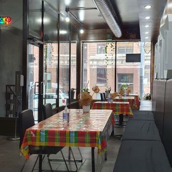 Riko Bokito - tables and benches in a restaurant - Caribbean Near Me - Toronto, Ontario
