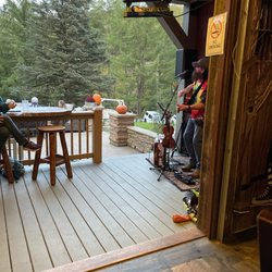 The Clarion River Lodge - Porch where entertainer performs looking out from inside the bar. Fire tables are to the left of the photo.