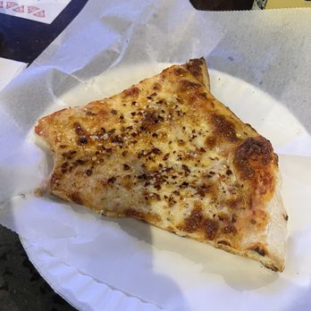 Miracle Pizza - New York Slice of cheese pizza with red pepper flakes on it - Pizza Near Me - Birmingham, Alabama
