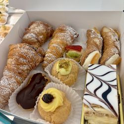 Pastries (lobster tails, eclair, fruit tart, cannoli, Napoleon, pistachio cream puff, and st Joseph Zeppole)