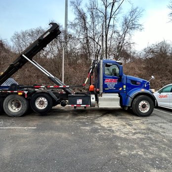 Suburban Carting - A Suburban Carting roll off truck picking up a compactor in New Rochelle, NY - Recycling Center Near Me - Briarcliff Manor, New York Suburban Carting - A Suburban Carting roll off truck picking up a compactor in New Rochelle, NY - Recycling Center Near Me - Briarcliff Manor, New York